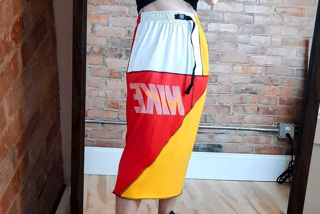 woman wearing colorblock patchwork nike skirt red, white, yellow