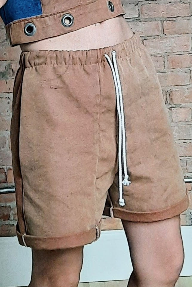 woman wearing brown cuffed shorts just above the knee with drawstring